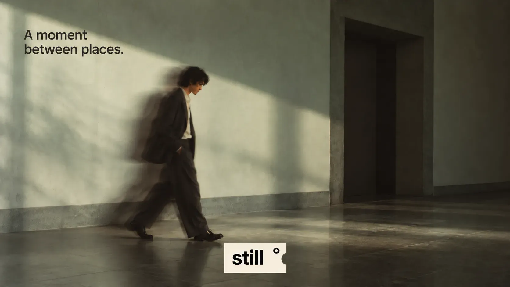 A moment between places campaign visual with a figure walking through a quiet hall