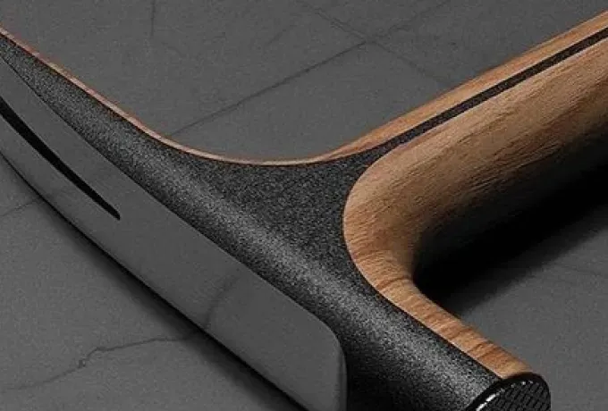 Close-up of a textured black tool handle with a walnut grip